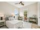 Bedroom with neutral walls, two windows for natural light, and decorative white bed frame at 13711 Lussier Ln, Spring Hill, FL 34610