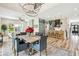 Open concept dining room with modern chandelier and view into kitchen and living room at 13711 Lussier Ln, Spring Hill, FL 34610