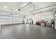 Spacious three car garage with epoxy floors and multiple windows for natural light at 13711 Lussier Ln, Spring Hill, FL 34610