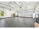 Spacious garage with high ceilings, epoxy flooring, and multiple overhead doors at 13711 Lussier Ln, Spring Hill, FL 34610