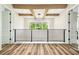 Hallway with modern lighting, wood beams, black railing and wood flooring at 13711 Lussier Ln, Spring Hill, FL 34610