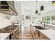 Beautiful kitchen features a marble countertop, farmhouse sink and chef's gas range; flows into the living area at 13711 Lussier Ln, Spring Hill, FL 34610