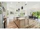 Spacious kitchen with island and stainless steel farmhouse sink, transitions to dining area and living area, perfect for gatherings at 13711 Lussier Ln, Spring Hill, FL 34610
