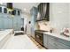 Gourmet kitchen with a marble countertop, and an elegant range hood, complemented by custom cabinetry and designer finishes at 13711 Lussier Ln, Spring Hill, FL 34610