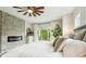 Comfortable main bedroom featuring a fireplace and balcony access at 13711 Lussier Ln, Spring Hill, FL 34610