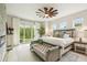 Comfortable main bedroom featuring a ceiling fan, balcony access, and natural light at 13711 Lussier Ln, Spring Hill, FL 34610