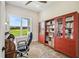 Bright office with built-in bookcases, desk, and large window overlooking the lawn at 13711 Lussier Ln, Spring Hill, FL 34610