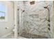 Modern bathroom featuring a glass-enclosed shower with marble tile and dual shower heads at 13711 Lussier Ln, Spring Hill, FL 34610
