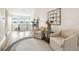 Cozy sitting area with two chairs, a round rug, and views from the windows at 13711 Lussier Ln, Spring Hill, FL 34610