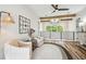 Sitting area with two chairs, modern lighting, and beams on the ceiling at 13711 Lussier Ln, Spring Hill, FL 34610