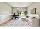 Serene sitting room featuring neutral color palette, comfortable seating, and natural light at 13711 Lussier Ln, Spring Hill, FL 34610