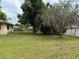 Spacious backyard with lush green lawn and mature trees, perfect for outdoor activities at 13742 14Th St, Dade City, FL 33525