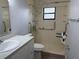 Accessible bathroom with safety bars, shower seat, and updated vanity at 13742 14Th St, Dade City, FL 33525