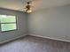 Cozy bedroom featuring neutral carpet, paint, and a ceiling fan at 13742 14Th St, Dade City, FL 33525