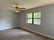Bedroom with ceiling fan and wood-look vinyl flooring and nice natural light at 13742 14Th St, Dade City, FL 33525