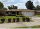 Charming single-story home features a well-maintained lawn, mature landscaping, and an attached two-car garage at 13742 14Th St, Dade City, FL 33525