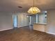 Open-concept living area with dining and kitchen, vinyl floors, neutral paint and modern lighting at 13742 14Th St, Dade City, FL 33525