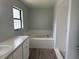 Bathroom features a soaking tub with tile surround, and modern vanity at 13742 14Th St, Dade City, FL 33525