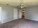 Main bedroom with en-suite bath, neutral paint, ceiling fan, carpet floors and large closets at 13742 14Th St, Dade City, FL 33525