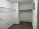 Spacious walk-in closet with wood-look vinyl floor, wire shelving and hanging racks at 13742 14Th St, Dade City, FL 33525