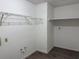 Spacious walk-in closet with wood-look vinyl floor, wire shelving and hanging racks at 13742 14Th St, Dade City, FL 33525