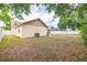 A spacious backyard with a fence, mature trees, and a well-maintained lawn at 1426 Buckner Rd, Valrico, FL 33596