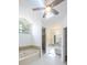 Bathroom with a soaking tub with tile surround, and an adjacent walk-in shower with a glass enclosure at 1426 Buckner Rd, Valrico, FL 33596