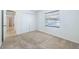 Bedroom with neutral carpet, a closet, a window with blinds, and white walls at 1426 Buckner Rd, Valrico, FL 33596