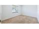 Bedroom with neutral carpet, a window with blinds, and white walls in natural sunlight at 1426 Buckner Rd, Valrico, FL 33596
