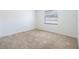 Bedroom with neutral carpet, a window with blinds, and white walls at 1426 Buckner Rd, Valrico, FL 33596