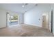 Bright bedroom with sliding glass doors to the backyard, neutral colors, and easy access to the connected bathroom at 1426 Buckner Rd, Valrico, FL 33596