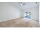 Large bedroom with sliding glass door for seamless access to the backyard and light neutral paint at 1426 Buckner Rd, Valrico, FL 33596