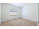 Bedroom with neutral carpet, a window with blinds, and white walls at 1426 Buckner Rd, Valrico, FL 33596