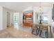 Open dining area with barstool seating and light fixture at 1426 Buckner Rd, Valrico, FL 33596
