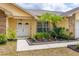 Welcoming front entrance featuring a double door, a well-landscaped garden, and mature palms at 1426 Buckner Rd, Valrico, FL 33596