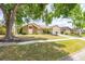 Charming home featuring mature landscaping, a well-manicured lawn, and an attached two-car garage at 1426 Buckner Rd, Valrico, FL 33596
