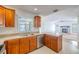 Updated kitchen with stainless appliances and light countertops connects to the bright and airy living room with a fireplace at 1426 Buckner Rd, Valrico, FL 33596