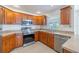 Spacious kitchen with stainless appliances, light countertops and wooden cabinets offer plenty of storage space at 1426 Buckner Rd, Valrico, FL 33596