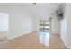 Bright living room featuring neutral walls, tile flooring, and sliding glass doors to the lanai at 1426 Buckner Rd, Valrico, FL 33596
