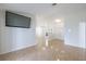 Bright living room featuring neutral walls, tile flooring, and an open floor plan at 1426 Buckner Rd, Valrico, FL 33596