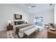 Bright main bedroom with sliding glass doors, bench, and modern decor at 1426 Buckner Rd, Valrico, FL 33596