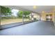 Spacious screened-in porch with a view of the landscaped backyard and the mature trees at 1426 Buckner Rd, Valrico, FL 33596