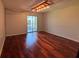Bedroom featuring sliding glass doors to the screened porch and hardwood flooring at 14446 Reuter Strasse Cir # 3, Tampa, FL 33613