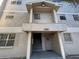 Multi-level apartment building featuring a welcoming entrance with decorative wreath and covered entry at 14446 Reuter Strasse Cir # 3, Tampa, FL 33613