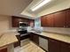 Kitchen with stainless steel appliances, granite counters, dark wood cabinets, and modern backsplash at 14446 Reuter Strasse Cir # 3, Tampa, FL 33613