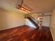 Living room with hardwood floors, staircase, and unique light fixture at 14446 Reuter Strasse Cir # 3, Tampa, FL 33613