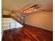 Living room with hardwood floors, staircase, and unique decorative lighting at 14446 Reuter Strasse Cir # 3, Tampa, FL 33613