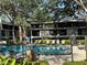 Community pool surrounded by lush landscaping and lounge chairs at 14446 Reuter Strasse Cir # 3, Tampa, FL 33613
