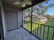 Relaxing screened porch overlooking lush green space with trees and landscaping at 14446 Reuter Strasse Cir # 3, Tampa, FL 33613