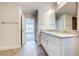 Bathroom featuring double sinks, granite countertops, wood tile, and ample lighting at 16511 66Th E Ln, Parrish, FL 34219